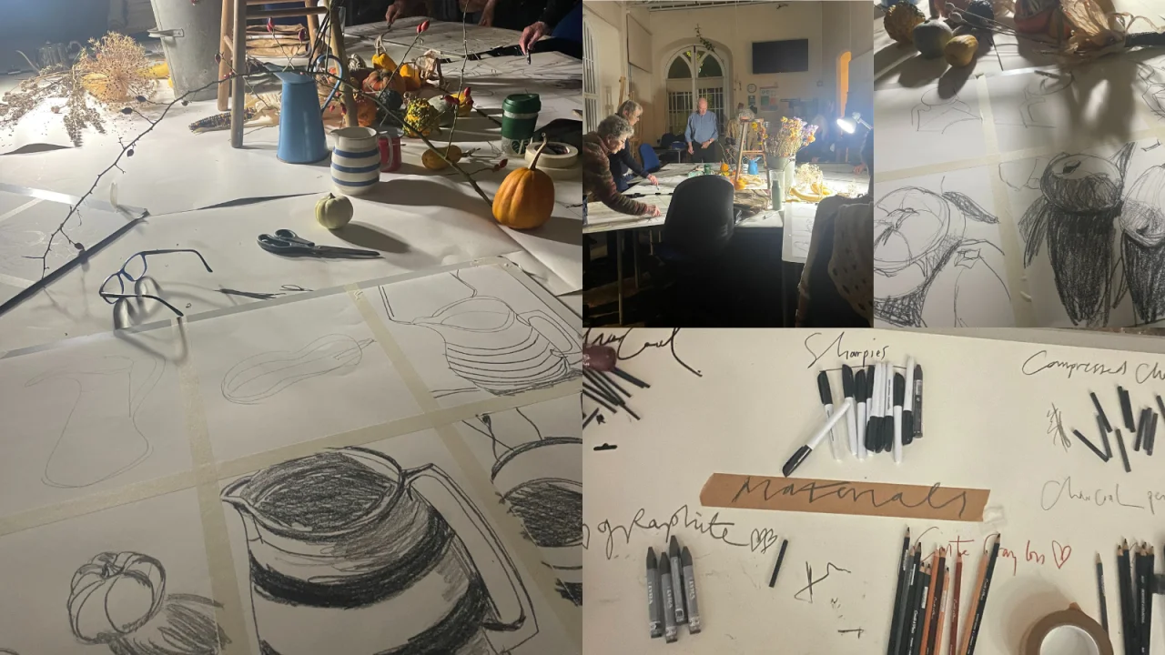 A selection of natural items are centrally displayed over paper, where artists have been sketching using graphite pencils.